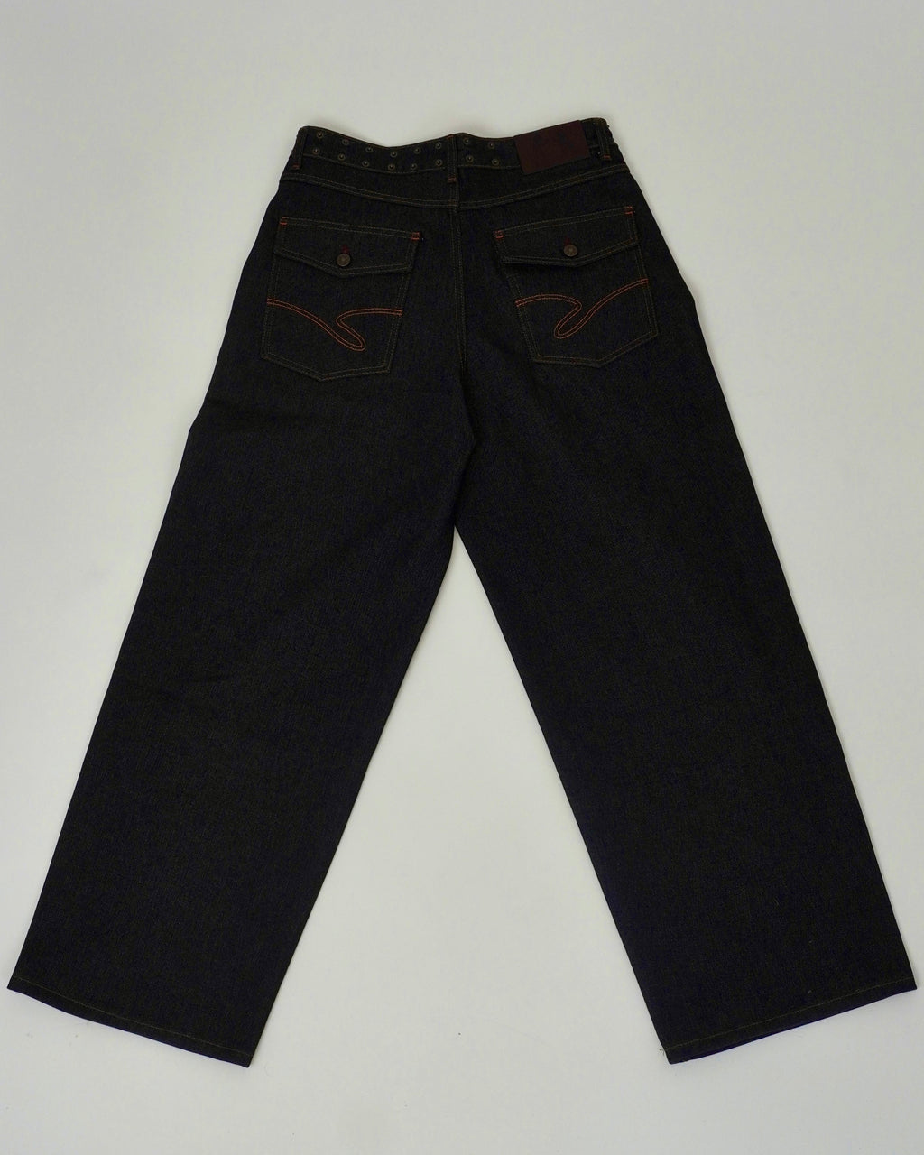 Pair of dark jeans on a light gray background