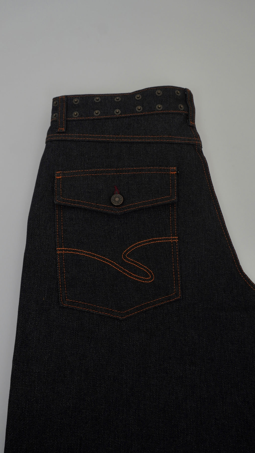 Dark denim apron with a pocket on a light gray background