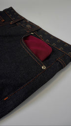 Dark blue jeans with a red pocket on a white background